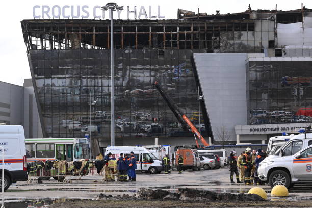 Emergency services personnel work by the burnt-out Crocus City Hall concert venue in Krasnogorsk, outside Moscow, on March 26, 2024. At least 139...