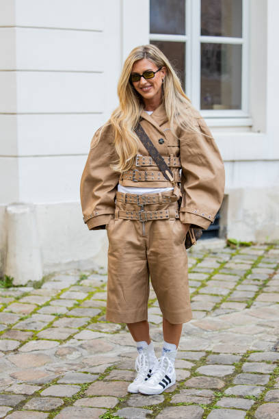 Emili Sindlev wears beige multi belted jacket, shorts, Louis Vuitton bag outside Ganni during the Womenswear Fall/Winter 2025/2026 as part of Paris...