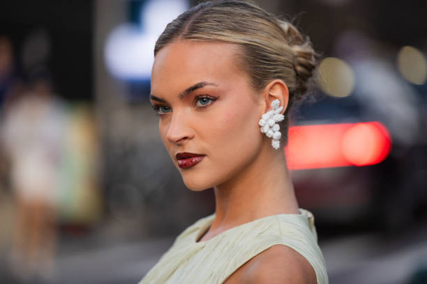 Emilia Silberg wears mint green dress, earrings outside Tory Burch during New York Fashion Week on September 09, 2024 in New York City.