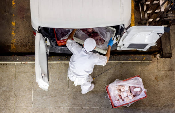employee loading meat on a van for delivery at a butcher's shop - food stock pictures, royalty-free photos & images