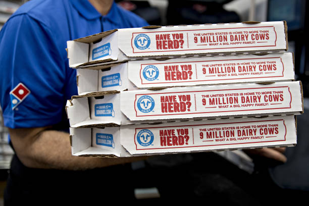 Employee moves pizza boxes before a delivery at a Domino's Pizza Inc. Restaurant in Chantilly, Virginia, U.S., on Tuesday, Feb. 20, 2018. Domino's...