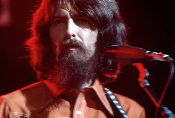 English musician, singer, songwriter, music and film producer and lead guitarist for the Beatles, George Harrison performs at his Concert For...