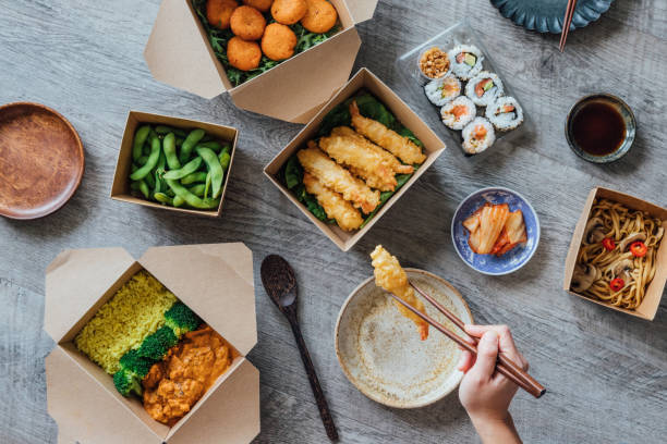enjoying assorted takeaway meal at home - junk food stock pictures, royalty-free photos & images