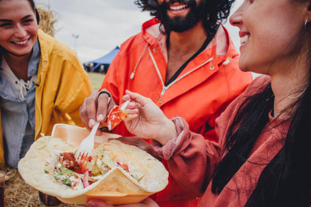 enjoying the food at a music festival - food stock pictures, royalty-free photos & images