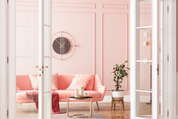 entrance of living room with pink sofa, potted plant and coffee table - home decoration stock pictures, royalty-free photos & images