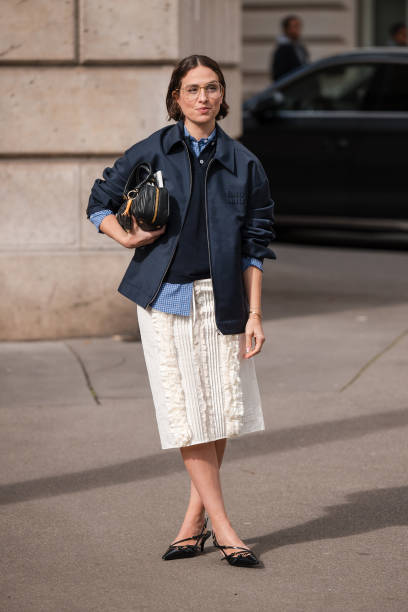 Erika Boldrin wears blue checked shirt, blue polo neck top, blue Miu Miu jacket, white decorated midi skirt, black heels, black Miu Miu bag, outside...