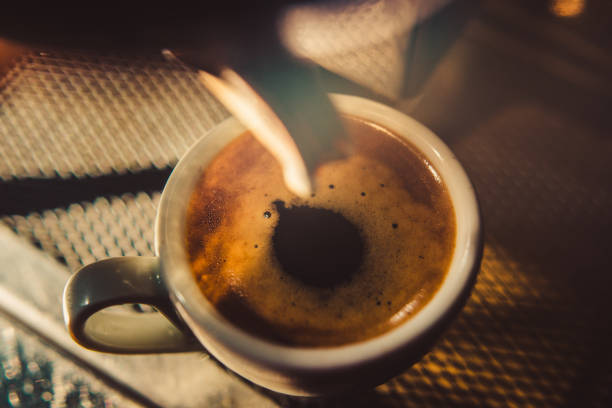 espresso shot pouring out of steamy machine. - coffee stock pictures, royalty-free photos & images