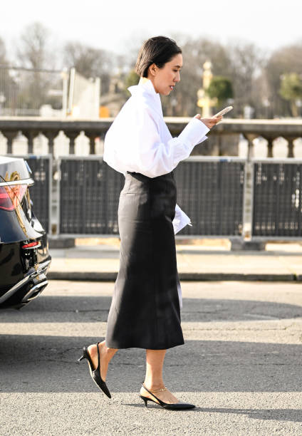 Eva Chen is seen wearing a white button down shirt, black skirt and black low heels outside the Dior show during the Womenswear Fall/Winter 2024/2025...