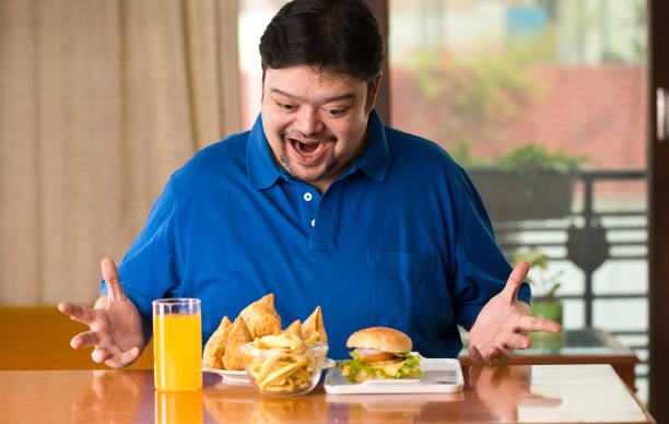 excited fat man with plate of samosa - junk food stock pictures, royalty-free photos & images