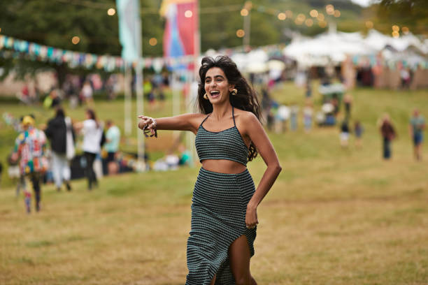 excited woman running at music festival - concert stock pictures, royalty-free photos & images