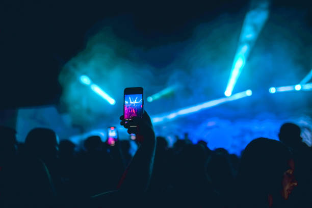 exciting lightning during dj party recorded by people on smartphones - concert stock pictures, royalty-free photos & images