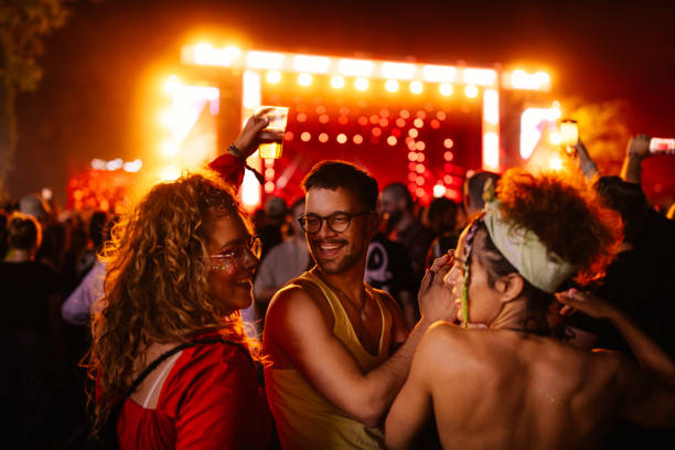 exhilarated people at concert - concert stock pictures, royalty-free photos & images