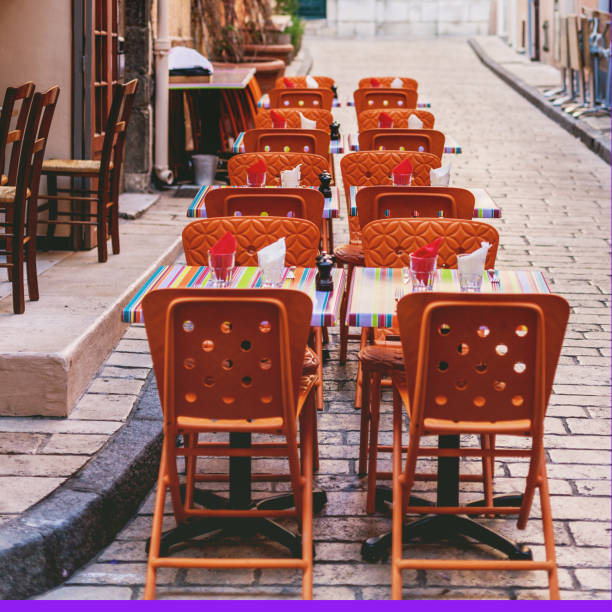 exterior of cafe with tables and chairs on street alongside stone wall, france - garden decoration stock pictures, royalty-free photos & images