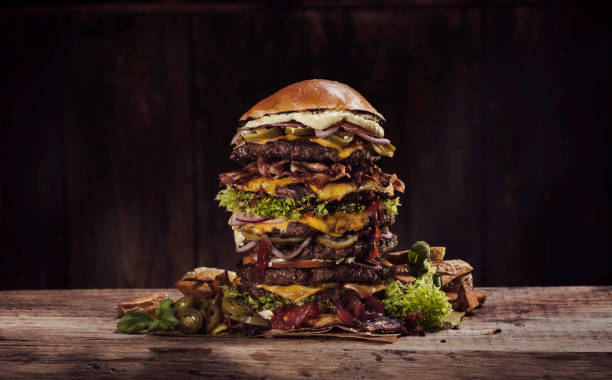 extra large cheese bacon burger - junk food stock pictures, royalty-free photos & images