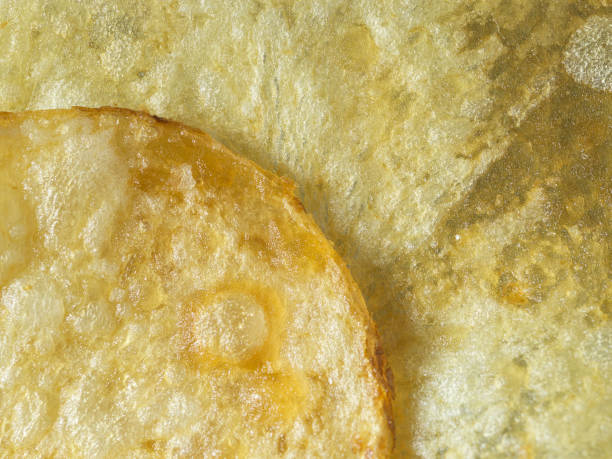 extreme close up textured and edge of potato chip - food stock pictures, royalty-free photos & images