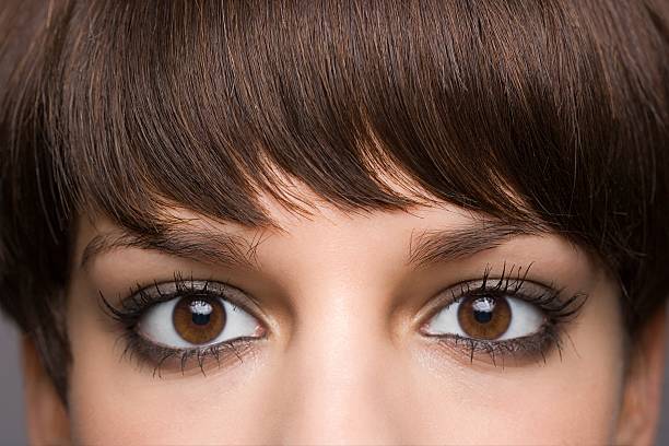eyes of a young woman - hairstyle stock pictures, royalty-free photos & images