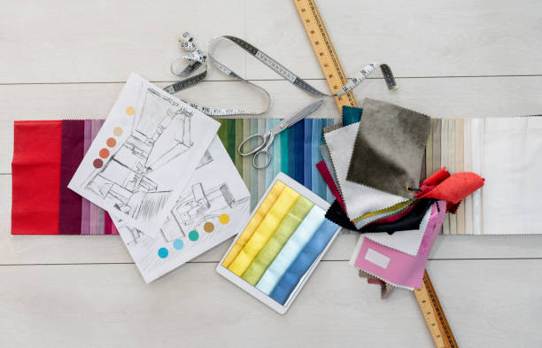 fabric swatches and tailoring tools on the table of a textile shop - fashion stock pictures, royalty-free photos & images
