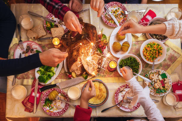 family celebrating christmas at home and playing with sparklers fireworks - food stock pictures, royalty-free photos & images