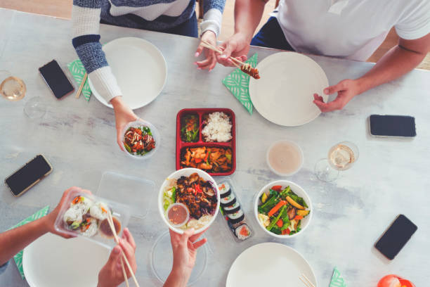 family eating take out food at home. - junk food stock pictures, royalty-free photos & images