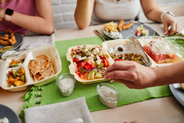 family eating takeaway meals at home - junk food stock pictures, royalty-free photos & images