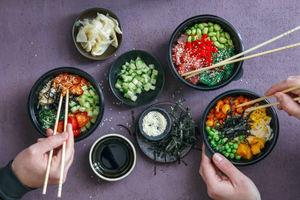 family eating takeaway poke bowls - junk food stock pictures, royalty-free photos & images