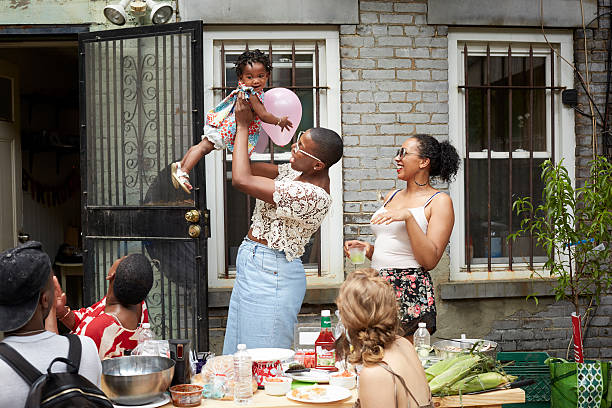 family enjoying backyard barbecue - garden decoration stock pictures, royalty-free photos & images