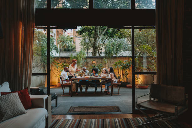 family gathered at the table at home - food stock pictures, royalty-free photos & images