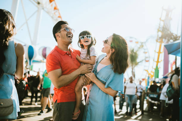 family has fun at outdoor carnival setting - travel stock pictures, royalty-free photos & images
