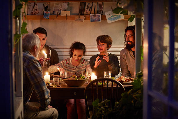 family having cozy dinner en garden house - food stock pictures, royalty-free photos & images