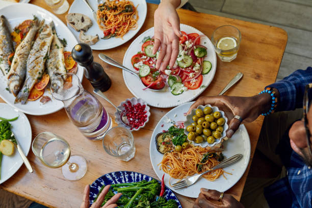 family having home cooked meal together - food stock pictures, royalty-free photos & images