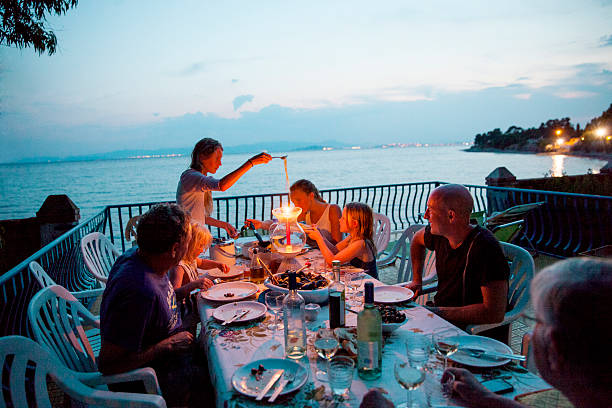 family having meal on patio - food stock pictures, royalty-free photos & images