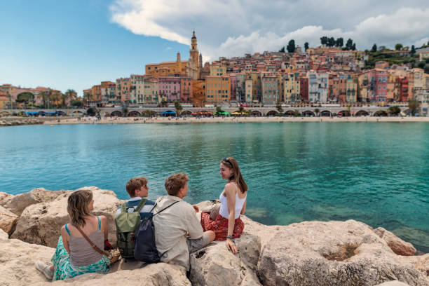 family looking at the beautiful town of menton, alpes-maritimes, france. - travel stock pictures, royalty-free photos & images