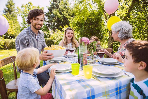 family of three generations at a garden party - garden decoration stock pictures, royalty-free photos & images