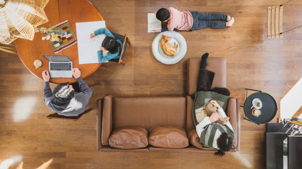 family relaxed with dogs in the living room, aerial view - home decoration stock pictures, royalty-free photos & images