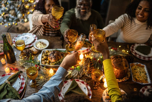 family toasting on christmas dinner at home - food stock pictures, royalty-free photos & images