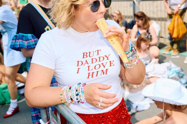 Fan enjoys an ice lolly as Swifties arrive to attend the concert of US singer and songwriter Taylor Swift as part of her 'Eras Tour' at Wembley...
