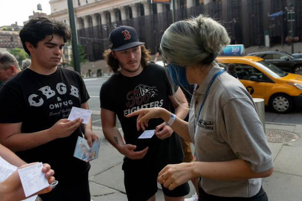 Fans have their COVID-19 vaccination cards checked before entering the Foo Fighters concert at Madison Square Garden on June 20, 2021 in New York...