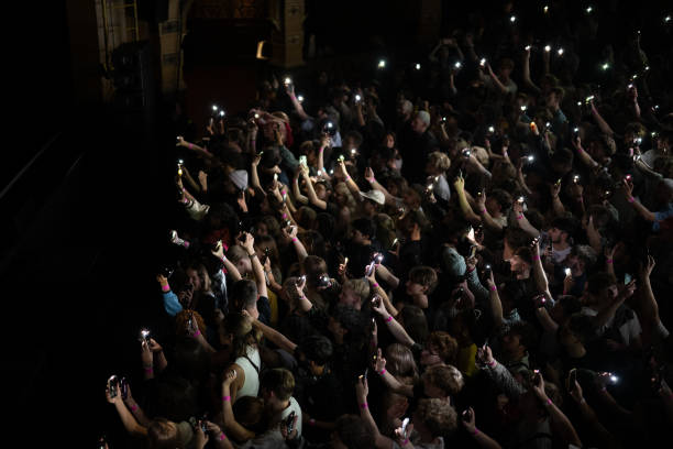 Fans light up the stage with their phone torches whlst Mac Demarco performs at Hackney Empire on July 30, 2023 in London, England.