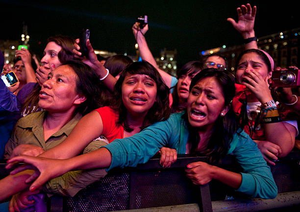 Fans of Canadian singer Justin Bieber cry during a concert at the Zocalo square, in Mexico City, on June 11, 2012. AFP PHOTO / RONALDO SCHEMIDT