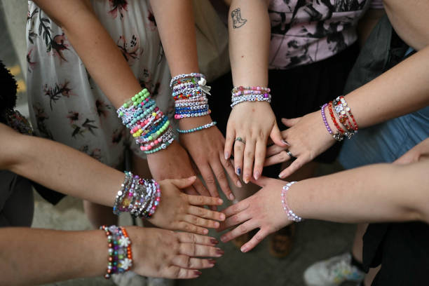 Fans of US mega-star Taylor Swift, so-called "Swifties", compare their bracelets as they gather outside Wembley Stadium in London on August 15 ahead...