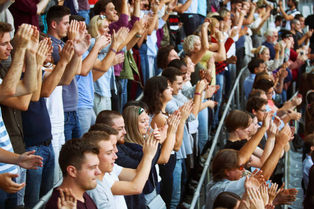 fans on the stadium clapping - concert stock pictures, royalty-free photos & images