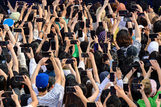 Fans use their phones as South Korean girl band Aespa performs as part of ABCs Good Morning America 2022 summer concert series at Central Park in New...