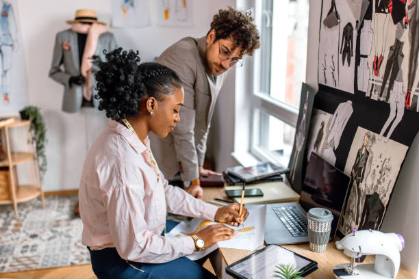 fashion designer and tailor working together in clothes design studio - fashion stock pictures, royalty-free photos & images