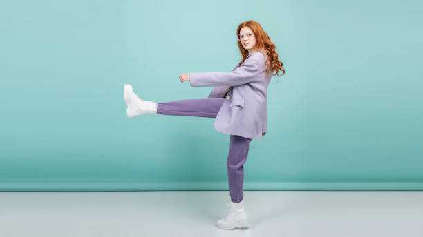 fashion model makes a step posing on a colored background with copy space. fashion and trend concept - fashion stock pictures, royalty-free photos & images
