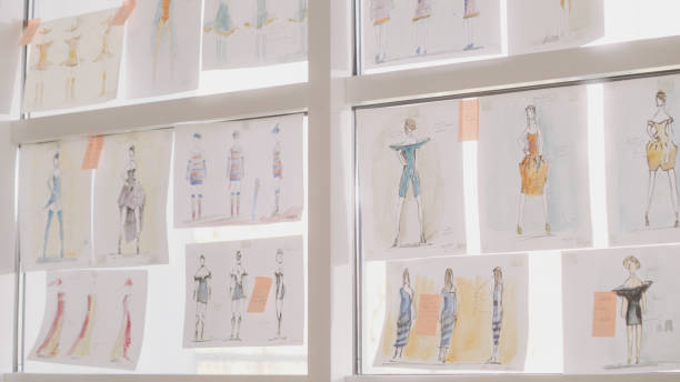 fashion projects hanging on a window. designer's studio - fashion stock pictures, royalty-free photos & images
