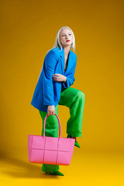 fashionable woman on plain background - fashion stock pictures, royalty-free photos & images