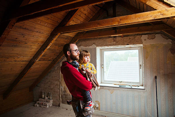 father and daughter examining attic under construction - home decoration fotografías e imágenes de stock