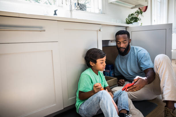 father and son doing home improvement project - home decoration stock pictures, royalty-free photos & images