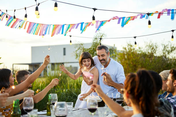 father celebrating birthday of daughter in yard - garden decoration stock pictures, royalty-free photos & images