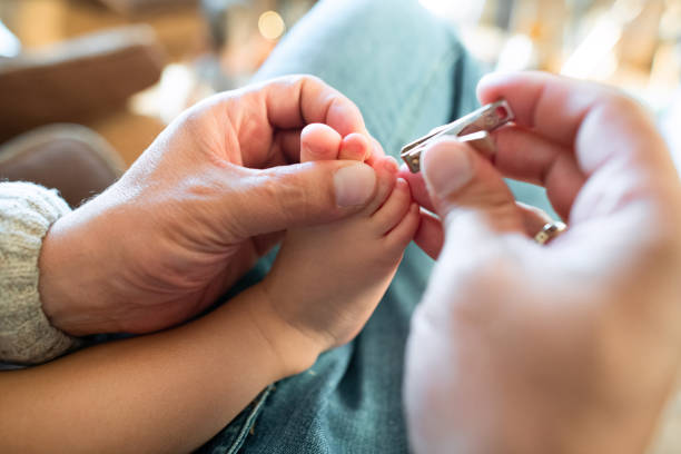 father taking care of his baby girl - nails art stock pictures, royalty-free photos & images